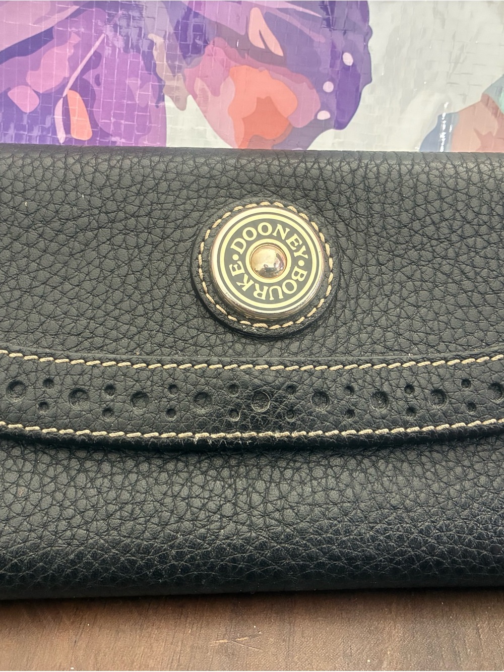 Dooney & Bourke Black Pebbled Leather Snap Wallet with Branded Medallion